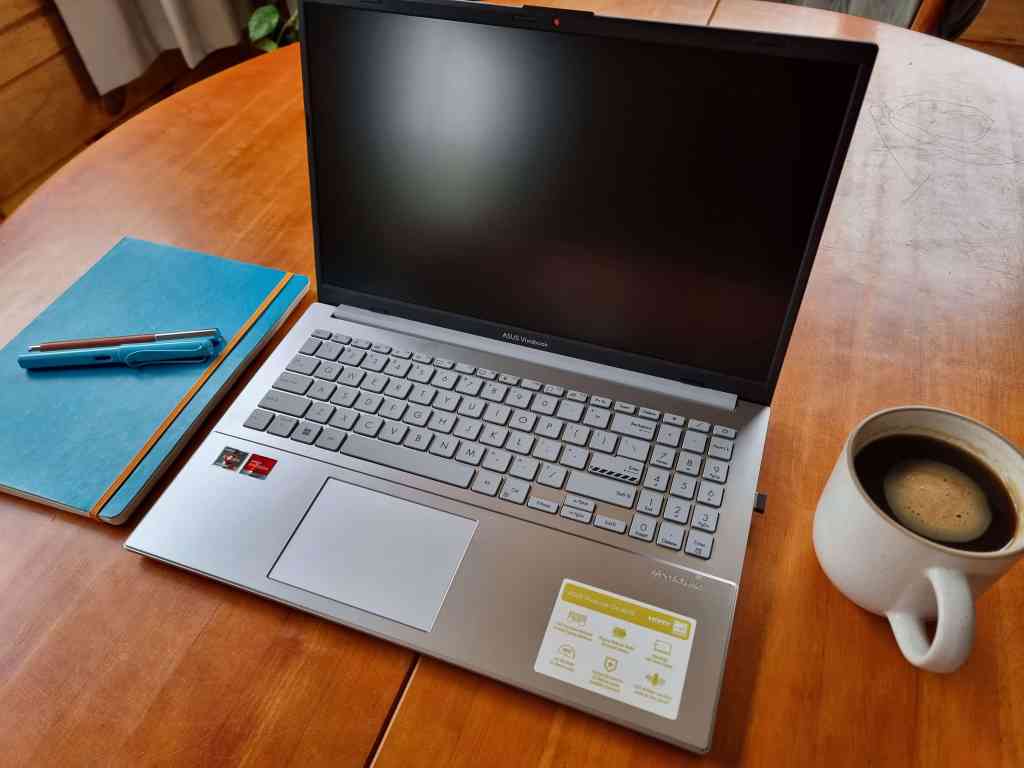 Picture of laptop, some stationery and a cup of coffee on a desk