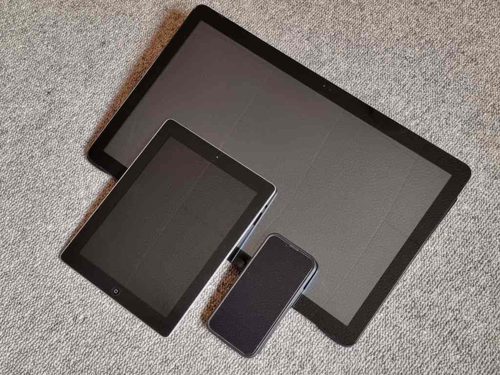 Picture of two tablets and a smartphone