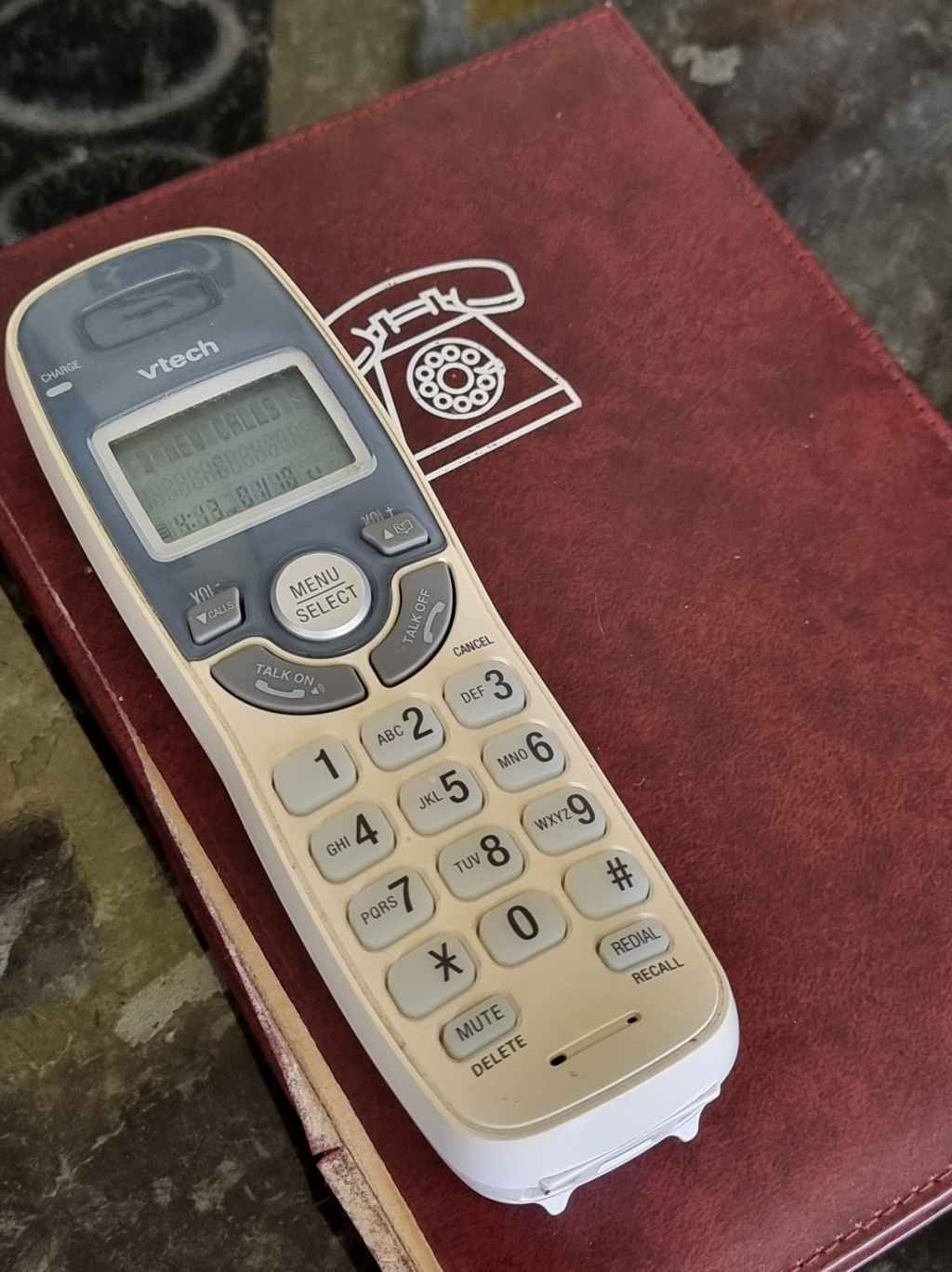 Picture of a landline phone set and an address book